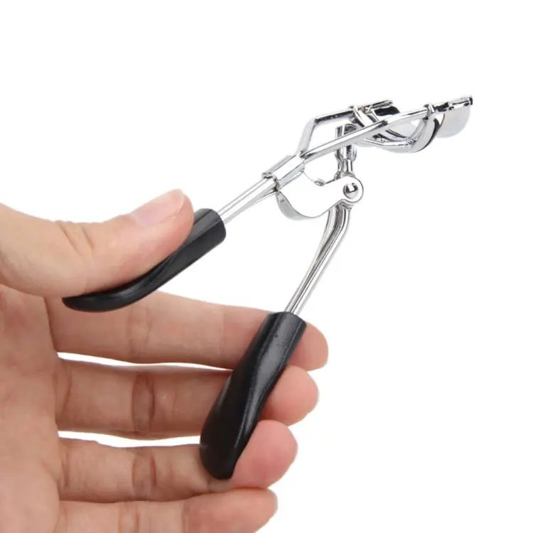 Hand holding a can opener with black handles on a white background