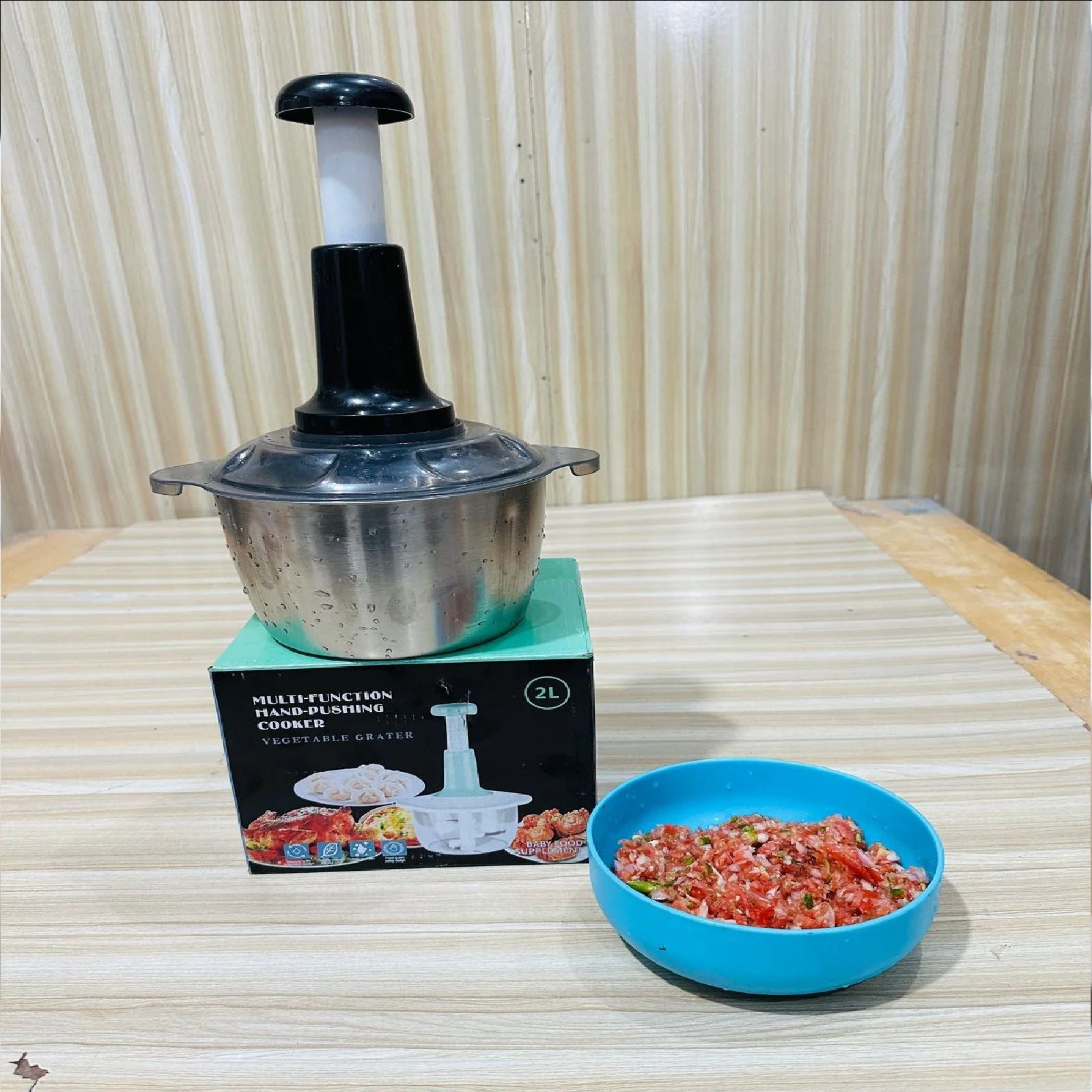 Person easily chopping onions using the push-button mechanism of the manual food chopper