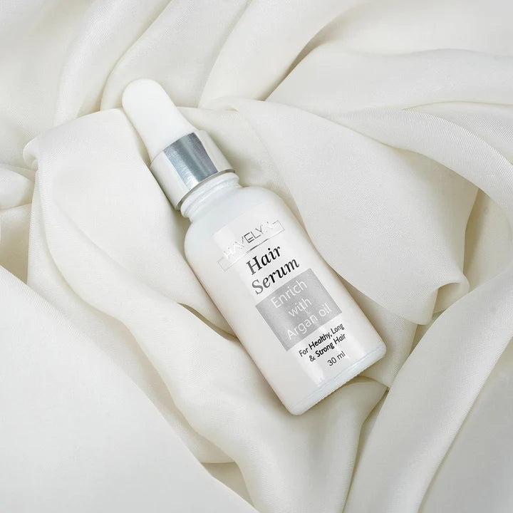 Woman applying Havelyn hair serum to smooth frizzy hair